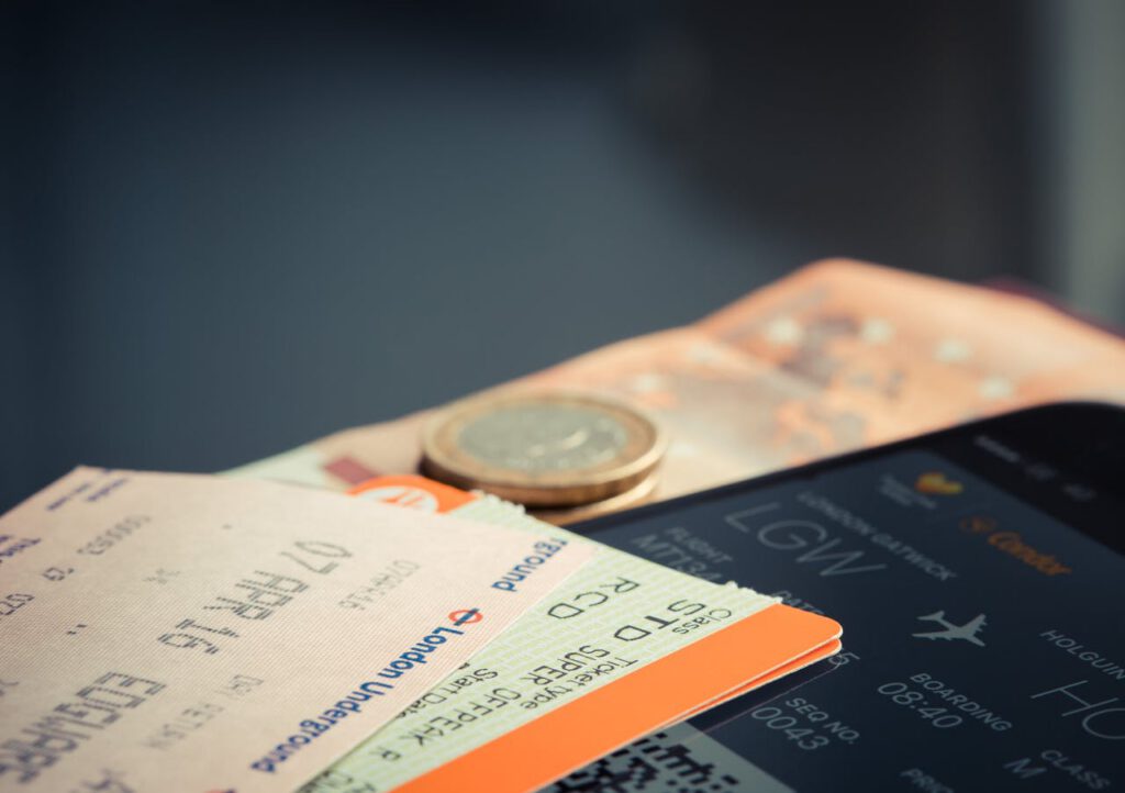 pexels-photo-69866 Airline ticket with euro coins and smartphone displaying flight details.