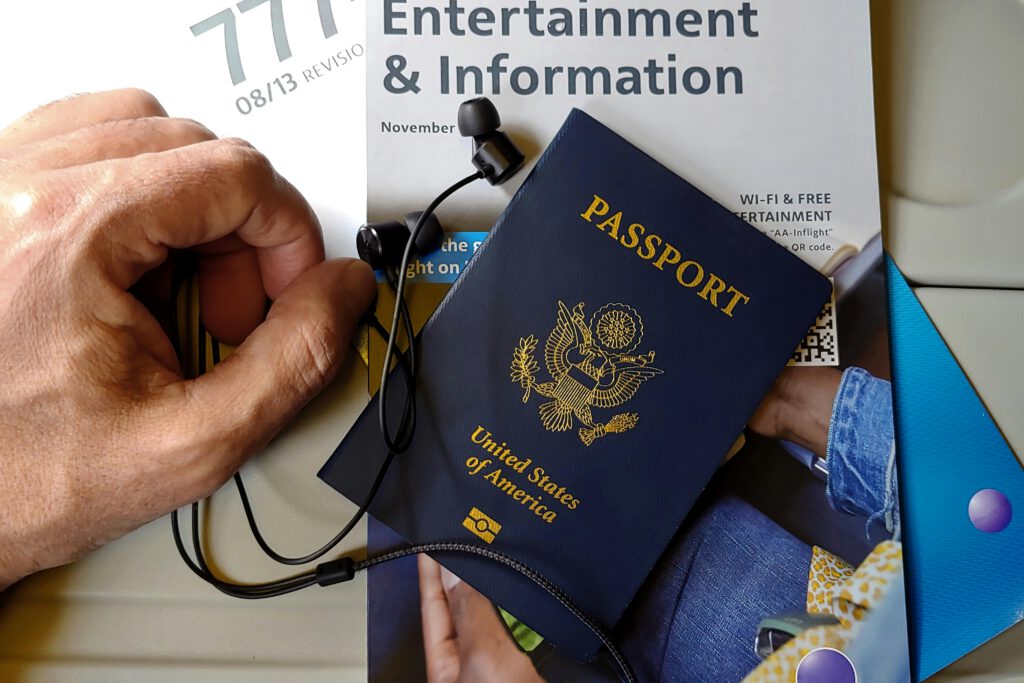 pexels-photo-32227477-32227477-1 Close up of a Hand next to an American Passport with Headphones